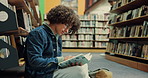 Student, man and reading a book in library for exam preparation, study insight and test knowledge. College, person and course resources on floor with thesis citation, research solution and education