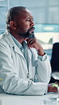 Thinking, science and black man on computer in lab for medical research, biology study and report. Healthcare, pharmaceutical and unsure scientist with plants for medicine, vaccine or digital results