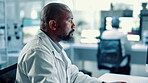Lab, scientist and mature man with computer, online and serious for medical research for innovation. Science, study and person with tech for breakthrough, analysis and cure for autoimmune disorder