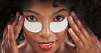 Beauty, face and black woman with eye patches for dark circles, collagen treatment and hydration. Skincare, person and happy with cosmetics product in studio for self care routine and hyaluronic acid