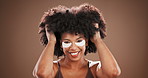 Beauty, afro or face of woman with eye mask in studio for dark circles, hydration and skincare. Haircare, african person and cosmetic product for anti aging and self care routine on brown background