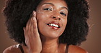 Skincare, woman face and apply with cream in studio, wellness shine and anti aging with collagen. Portrait, female person and cosmetics with lotion for beauty, moisturizer and isolated background