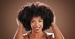 Face, haircare and woman with afro, studio and confident for growth of hair, beauty and dermatology. Brown background, black person and shine of hairstyle with cosmetics, texture and glow of skin