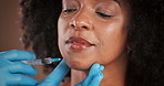 Beauty, chin filler and needle with black woman in studio for antiaging or plastic surgery procedure. Face, hands of doctor and syringe with person in clinic for cosmetic treatment or injection