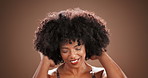 Afro, beauty and hair with shake with black woman in studio for natural textures, self care or cosmetics. Volume, shampoo and growth with person on background for cosmetology and salon transformation