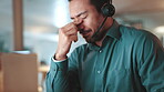 Night, businessman and tired with headache, stress or overworked with call center deadline. Person, employee and migraine with burnout, fatigue or exhausted with eye strain and typing consultant