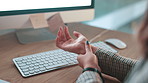 Typing, carpal tunnel and businesswoman in office with wrist pain, injury or accident with fibromyalgia. Keyboard, osteoporosis and female copywriter with muscle sprain in hand by desk in workplace.