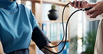 Blood pressure, consultation and doctor with woman in clinic for heart health, pulse or checkup. Sphygmomanometer, medical and physician with female patient for hypertension assessment in hospital.