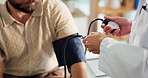 Blood pressure, hands and doctor with man in clinic for heart health, pulse or consultation. Sphygmomanometer, medical and physician with patient for hypertension assessment in hospital for checkup.