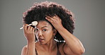 Face, brush and black woman in studio, cosmetics and foundation on grey background. Portrait, happy person and model with makeup tools, aesthetic and skincare with beauty, grooming and dermatology