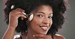 Beauty, facial roller and face of black woman in studio for natural, skincare or lymphatic drainage. Dermatology, portrait and person with cosmetic tool for blood circulation by gray background.