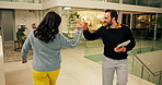 Office, night or employees with fist bump, greeting and smile with colleagues, positive energy or good mood. Walk, high five and people in workplace with handshake, friendship and fun in overtime