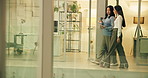 Walking, tablet and business women in office for online review, project and website search at night. Creative, collaboration and workers on digital tech for copywriting report, meeting and discussion