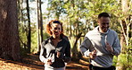 Fitness, happy and friends running in forest for marathon practice, conversation and teamwork. Cardio club, group and jog together in woods for workout, exercise or training routine on outdoor trail