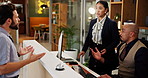 Angry, man and complaining to manager, hotel and disappointed with customer service, talk and upset. Motel, receptionist and conversation with unhappy guest, explaining and assistance for tourist