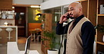 Phone call, man and concierge at front desk in hotel for booking reservation or view appointment. Hospitality, customer care and male receptionist with communication for room service at accommodation