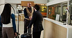Hotel, arrival or people handshake with concierge for business travel, welcome or help with luggage. Hospitality, colleagues or shaking hands with employee for check in, greeting or escort assistance