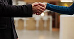Hotel, reception and people with handshake for greeting, introduction or help for accommodation. Closeup, client or concierge with shaking hands for welcome, hospitality service or check in for guest