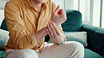 Man, hands or wrist pain in home with massage, carpal tunnel or poor blood circulation on sofa. Person, muscle sprain or sore in lounge with joint inflammation, tendinitis or repetitive strain injury