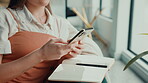 Phone, notebook and hands with woman on sofa for inspiration, journal prompt or reminder. Research, agenda and planning with closeup of person in living room of home for diary, online or list