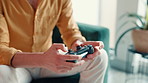Hands, video game and man with controller in home for playing online, entertainment and esports. Gamer, living room and person relax for virtual media, digital streaming and competition on weekend