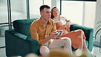 Concentration, gaming and ignore with couple on sofa in living room of home for relationship. Annoyed, distraction or frustrated with gamer man and woman in apartment for challenge or competition