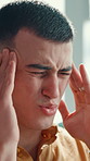 Frustrated man, headache and pain with stress for vertigo, dizziness or mental health at home. Male person, ache or sore head with massage or migraine for muscle tension or eye strain at house