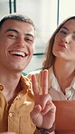 Peace sign, selfie and face of couple in home with bonding, happy and date memory in living room. Smile, connection and portrait of people for photography picture with love, care and relationship.