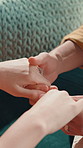 Home, holding hands and couple with love, closeup and bonding together with support. Apartment, man and woman on sofa, romance and kindness with empathy, relationship and marriage with gratitude