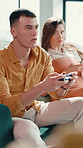 Couple, video game and annoyed woman in home for attention, ignore partner and addiction. Gamer, people and playing online challenge on sofa with frustrated girlfriend, streaming competition or hobby