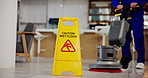 Janitor, person and caution sign with sanitation service, wet floor and disinfection in office. Hygiene, safety and warning for risk, cleaning and cleaner with tile polishing equipment or maintenance
