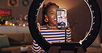 Makeup, influencer and ring light with black woman and phone for cosmetics promotion, brand and vlog. Beauty sponsorship, follower engagement and content creator with person in home for recording