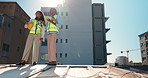 Teamwork, inspection or women on building site for engineering, construction or project. Low angle, rooftop or architects talking in renovation for city development with checklist, tablet or safety 