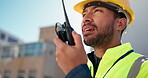 Man, construction and talking with radio on site for building inspection, instructions or workflow. Engineer, low angle or communication for project management, quality control or renovation progress