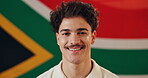 Face, man and nationality with flag for South Africa, smile and pride with happiness for citizen. Portrait, male person or patriotic with confidence for fabric, country or positive attitude by symbol