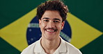 Man, face and smile with Brazil flag in studio for national pride, confidence and patriot by background. Person, model and happy in portrait with symbol, respect and sign with loyalty to country