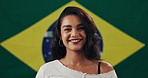 Girl, face and happy with flag for Brazil with national pride, confident or patriot by background. Woman, model and smile for democracy in portrait with symbol, respect or sign for loyalty to country