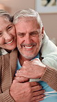 Hug, love and trust with senior couple in living room of retirement home together for affection. Bonding, marriage or smile with elderly man and woman embracing in apartment for safety or security