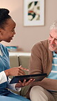 Nurse, senior man and tablet with conversation, consultation and wellness in home. Mature patient, caregiver with technology in lounge with digital schedule for retirement, medication and advice