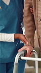 Nurse, hands and patient with walker for elderly care, mobility or assisted living at home. People, caregiver or physiotherapist with walking aid for muscle recovery or balance at old age house