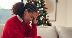 Crying, christmas and woman on sofa in home with unemployment, broke or financial crisis in living room. Sad, depression and person on xmas with emotions, tears and hopeless for finance problem.