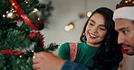 Christmas, tree and couple in home with decoration for holiday, vacation and festive season. December, love and people with baubles, ornaments and sparkle for xmas tradition, bonding and celebration