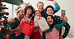 Gifts, selfie and friends by christmas tree in home for bonding, celebration and memory together. Happy, presents and group of people with photography picture at xmas event for social media in house.