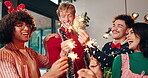 Christmas, sparkler and dance with friends at party for celebration, social reunion and festive. Merry xmas, cheers and smile with group of people in living room of home for holiday season and event