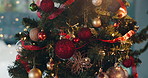 Christmas, bauble and decorations on tree for holiday celebration, tradition or festive closeup. Glitter ball, ornament or Xmas event with lights for creativity, aesthetic and bokeh with sparkle