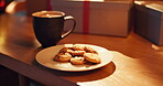 Gift, cookies or coffee in home for Christmas celebration, tradition or warm beverage. Hot chocolate, morning or sweet snack with tea for holiday, food or festive treats with present, biscuits or box
