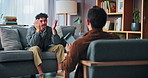 Counseling, anxiety and student on sofa with therapist for help, support and advice for college stress. Mental health, therapy and guidance counsellor with man worry for exams, burnout and failure