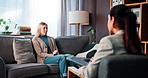 Therapy, sofa and woman with talking for counseling, anxiety management and healing with therapist. Psychology, female patient and psychologist with tablet for assessment, listening and share trauma