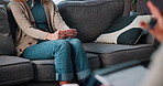 Anxiety, hands and psychologist with patient on sofa for counseling, mental health and discussion. Therapy session, trauma rehabilitation and healing with people in clinic for support and progress