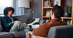Counseling, talking and psychology with man on sofa for anxiety, mental health and discussion. Therapy session, trauma rehabilitation and healing with person in clinic for support and progress